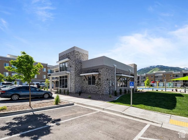 view of property featuring uncovered parking and a mountain view