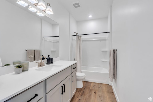 bathroom featuring shower / tub combo, vanity, recessed lighting, toilet, and wood finished floors