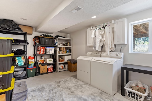 washroom featuring recessed lighting, visible vents, washer and clothes dryer, and cabinet space