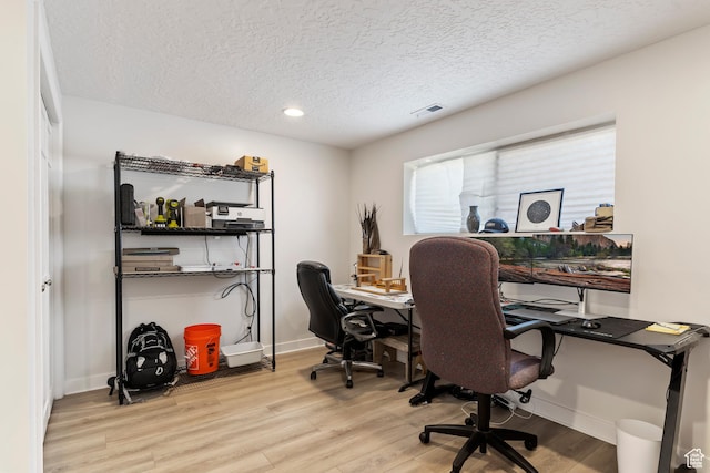 office space featuring a textured ceiling, visible vents, recessed lighting, wood finished floors, and baseboards