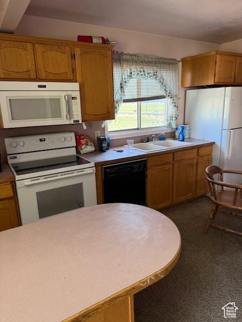 1439 N Westside Hwy W, Dayton, ID 83232 - kitchen with light countertops, brown cabinets, a sink, and white appliances