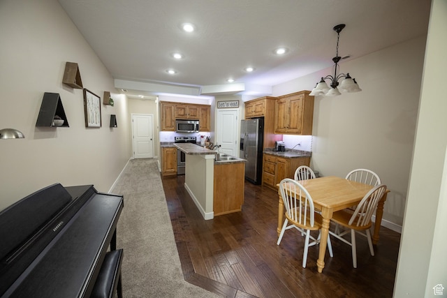 1221 W 2415 S, Nibley, UT 84321 - kitchen with dark wood-style flooring, brown cabinets, recessed lighting, stainless steel appliances, and a kitchen island