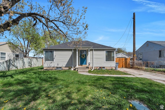bungalow with a front yard and fence