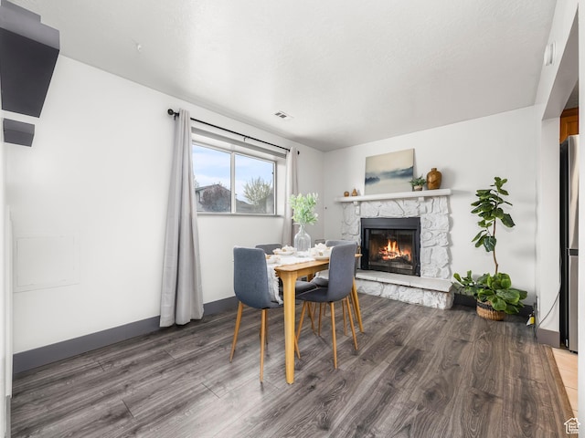 4866 W Diamondleaf Way S, West Jordan, UT 84081 - dining space with wood finished floors, a fireplace, and baseboards