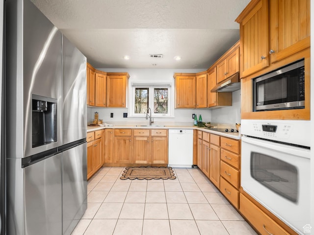 4866 W Diamondleaf Way S, West Jordan, UT 84081 - kitchen featuring a sink, light countertops, under cabinet range hood, and stainless steel appliances