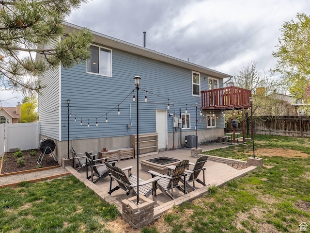 4866 W Diamondleaf Way S, West Jordan, UT 84081 - back of house with an outdoor fire pit, a patio area, a fenced backyard, and a lawn