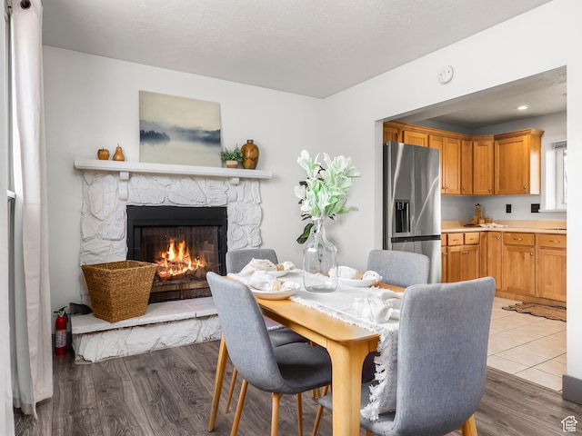 4866 W Diamondleaf Way S, West Jordan, UT 84081 - dining space with a stone fireplace and wood finished floors