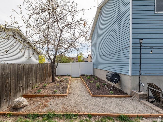 4866 W Diamondleaf Way S, West Jordan, UT 84081 - view of yard featuring a garden, fence private yard, and a gate