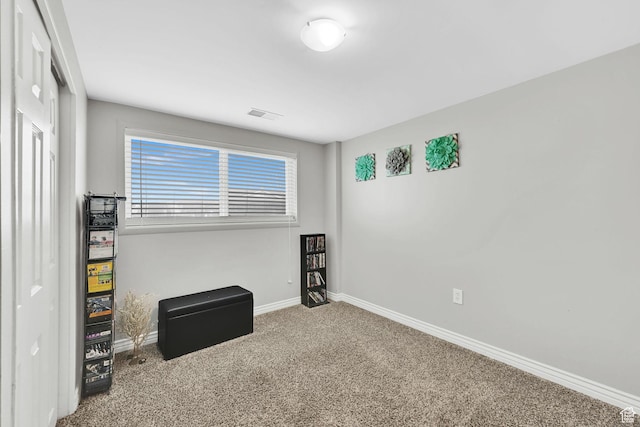 carpeted empty room featuring visible vents and baseboards