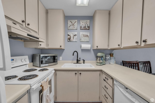 kitchen featuring under cabinet range hood, white appliances, light countertops, and a sink