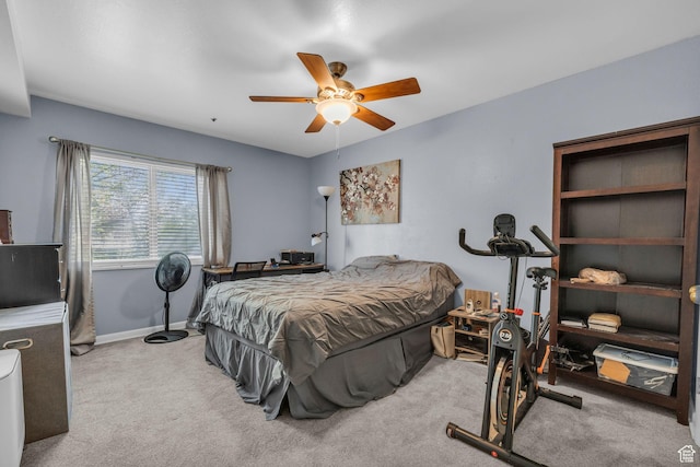 carpeted bedroom with baseboards and a ceiling fan