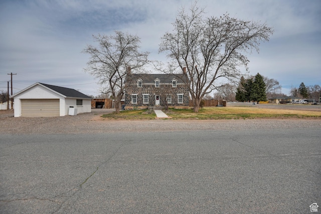 view of front of home with a chimney and a garage