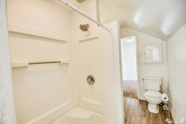 full bath featuring walk in shower, vaulted ceiling, toilet, and wood finished floors