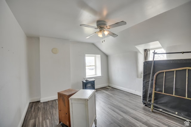 bonus room with baseboards, wood finished floors, a ceiling fan, and lofted ceiling