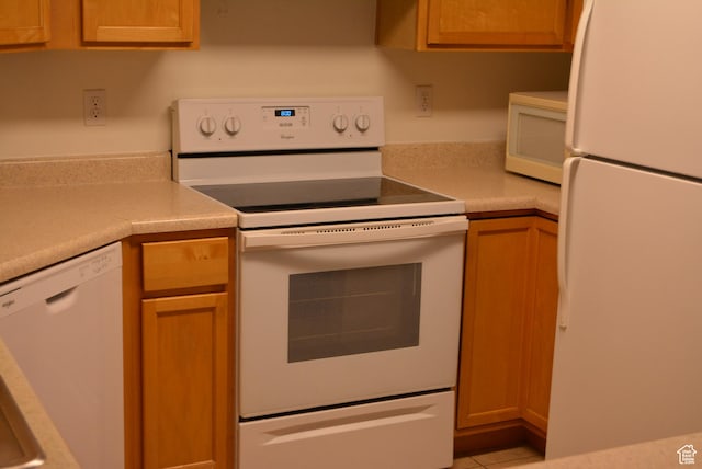1617 W Treille Ct Unit I-5, West Valley City, UT 84119 - kitchen featuring light tile patterned floors, white appliances, and light countertops