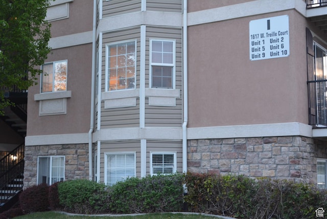 1617 W Treille Ct Unit I-5, West Valley City, UT 84119 - view of home's exterior with stone siding and stucco siding