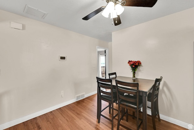 dining area featuring wood finished floors, baseboards, and visible vents