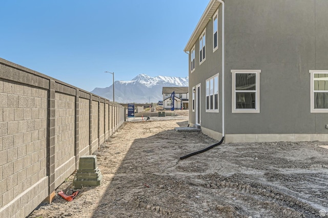 view of yard with a mountain view and a fenced backyard