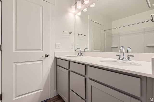 full bath with double vanity and a sink