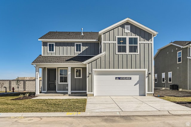 view of front of home featuring board and batten siding, an attached garage, a shingled roof, and concrete driveway