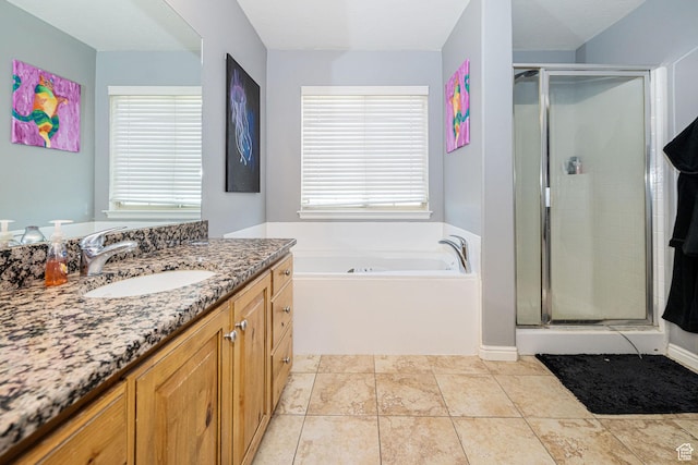 bathroom featuring vanity, a garden tub, and a stall shower