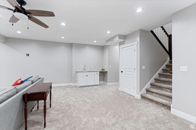recreation room featuring baseboards, recessed lighting, light colored carpet, and a sink