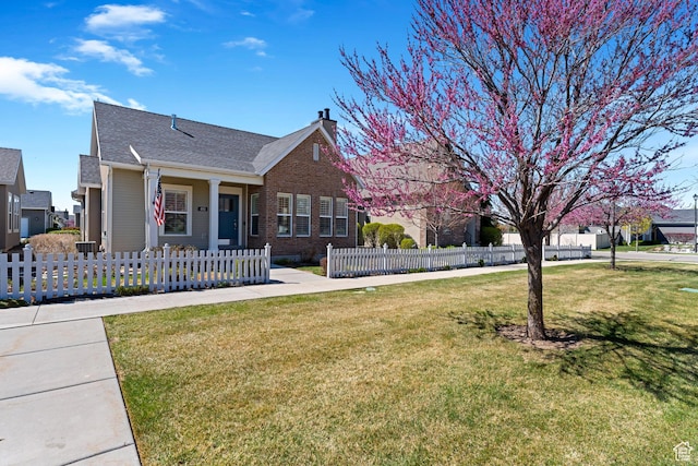 view of front of home featuring a front lawn, a shingled roof, a fenced front yard, a chimney, and brick siding