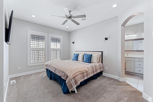 carpeted bedroom featuring visible vents, ceiling fan, baseboards, arched walkways, and recessed lighting
