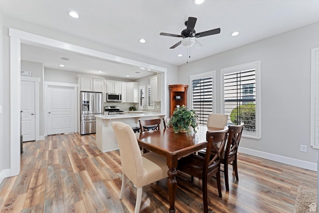 dining space with ceiling fan, light wood-type flooring, recessed lighting, and baseboards