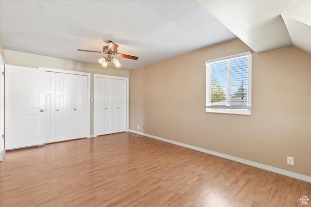 282 E 9545 S, Sandy, UT 84070 - unfurnished bedroom with two closets, baseboards, a ceiling fan, and light wood-type flooring