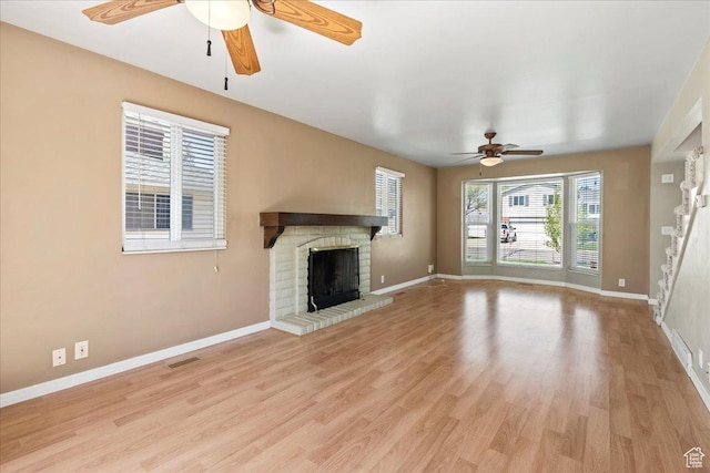 282 E 9545 S, Sandy, UT 84070 - unfurnished living room with light wood-style floors, a fireplace, a ceiling fan, and baseboards