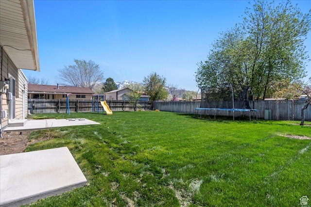 282 E 9545 S, Sandy, UT 84070 - view of yard featuring a fenced backyard, a trampoline, and a playground