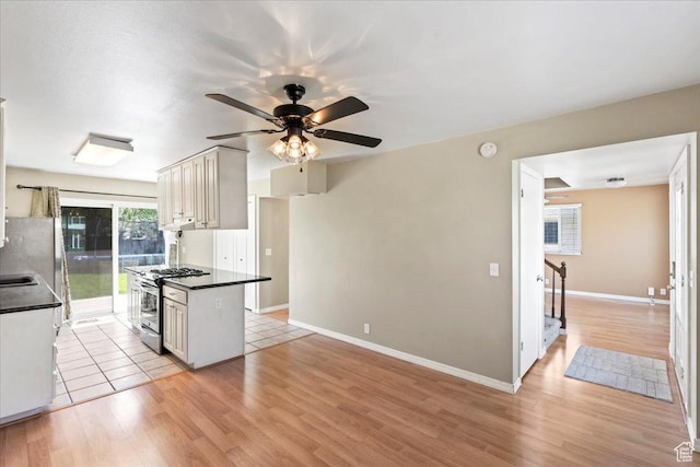 282 E 9545 S, Sandy, UT 84070 - kitchen featuring baseboards, a ceiling fan, dark countertops, light wood finished floors, and stainless steel appliances