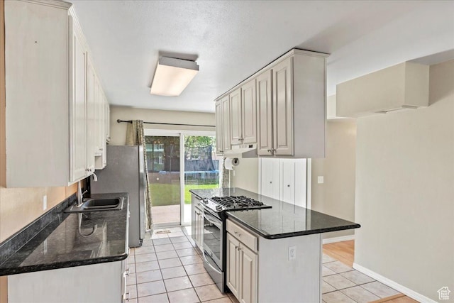 282 E 9545 S, Sandy, UT 84070 - kitchen with dark stone counters, light tile patterned flooring, a sink, stainless steel appliances, and baseboards