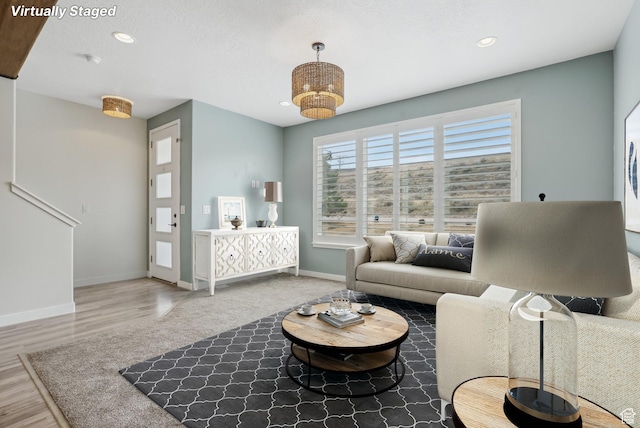 living room featuring recessed lighting, wood finished floors, and baseboards