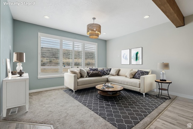 living room featuring recessed lighting, baseboards, and beamed ceiling