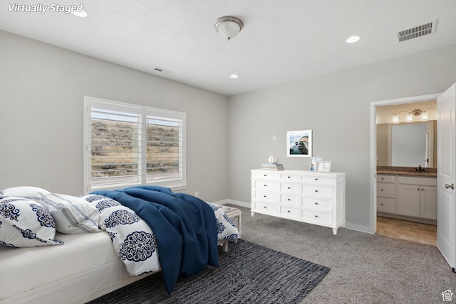 bedroom featuring light carpet, visible vents, connected bathroom, and recessed lighting