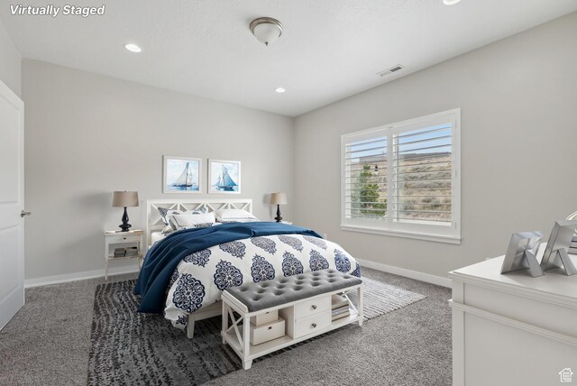 carpeted bedroom featuring baseboards, visible vents, and recessed lighting