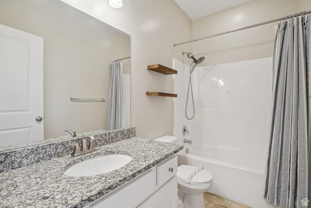 bathroom with toilet, shower / tub combo, vanity, and tile patterned flooring
