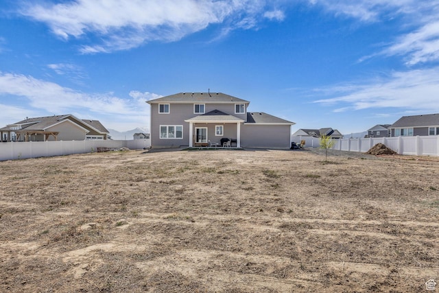 back of house featuring a fenced backyard and a patio area