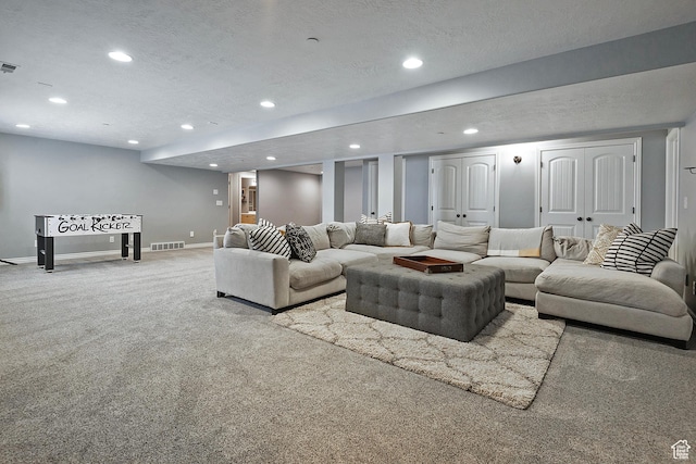 carpeted living room featuring visible vents, baseboards, recessed lighting, and a textured ceiling