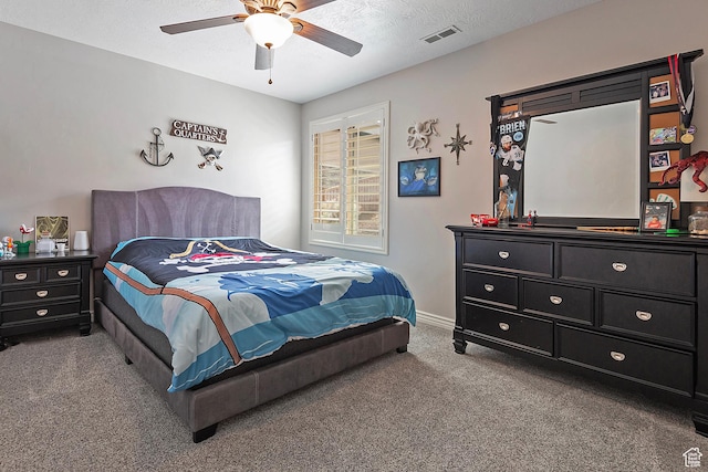 bedroom with ceiling fan, carpet flooring, baseboards, and visible vents