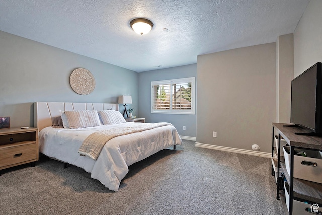bedroom featuring baseboards, carpet, and a textured ceiling