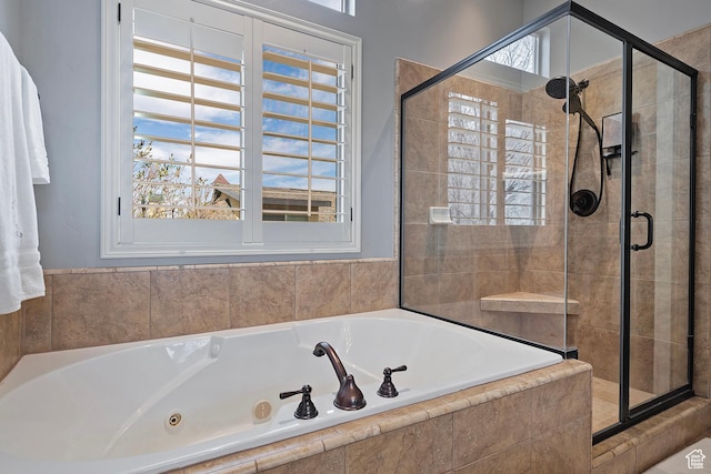 full bathroom featuring a bath and a shower stall
