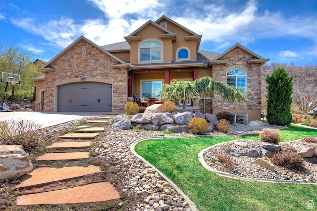 craftsman house with a garage, covered porch, stucco siding, stone siding, and driveway