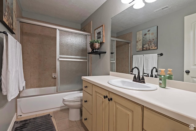 full bath featuring vanity, tile patterned floors, a textured ceiling, toilet, and visible vents