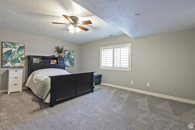 bedroom featuring visible vents, baseboards, a textured ceiling, and carpet floors