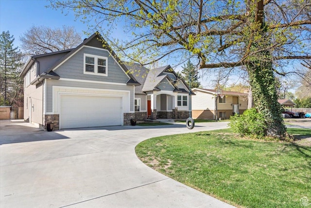 craftsman-style house with concrete driveway, a front lawn, stone siding, and an attached garage