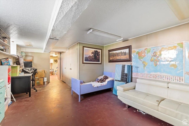 bedroom featuring a textured ceiling and finished concrete floors