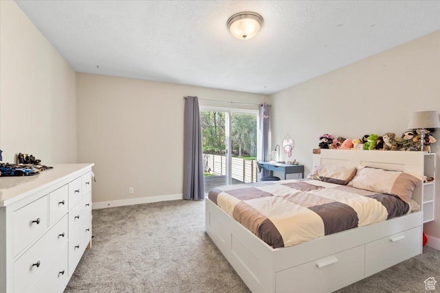 bedroom with access to outside, light carpet, baseboards, and a textured ceiling